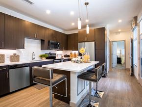 Westminster apartment for rent - a kitchen with a large island with two chairs