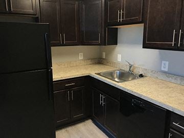 Lexington Park apartment for rent - a kitchen with a sink and a black refrigerator