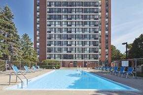 Mississauga apartment for rent - a swimming pool at a hotel in front of a building