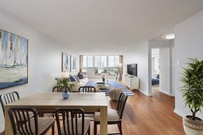 Mississauga apartment for rent - an open living room and dining room with a table and chairs