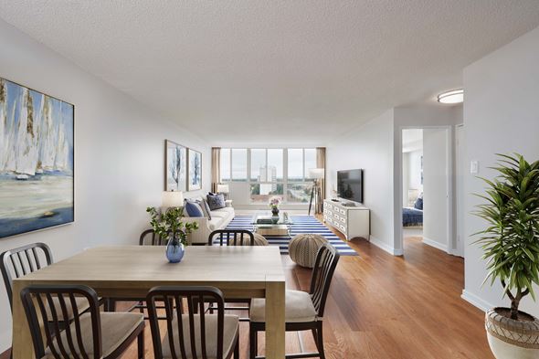 Mississauga apartment for rent - an open living room and dining room with a table and chairs