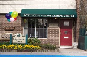 Charleston apartment for rent - a townhouse village leasing center with balloons in front of it