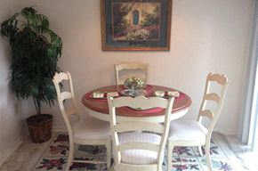Charleston apartment for rent - a dining room table with three chairs and a plant