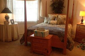 Charleston apartment for rent - a bedroom with a four poster bed and a table with books