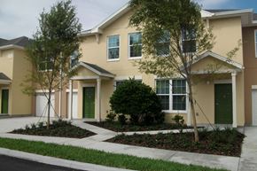 Deland apartment for rent - a house with a sidewalk and trees in front of it