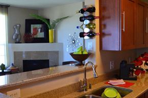 Parker apartment for rent - a kitchen with a sink and some wine bottles on the wall