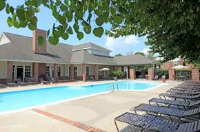 Martinsburg apartment for rent - a swimming pool with chairs around it in front of a building