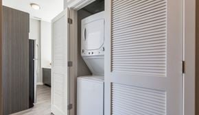 Chicago apartment for rent - A white washing machine is in a small laundry room.