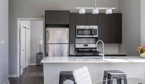 Chicago apartment for rent - A modern kitchen with a white countertop and a stainless steel refrigerator.
