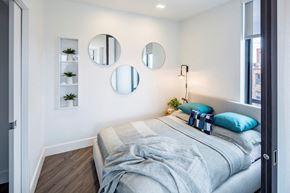 Washington apartment for rent - a bedroom with a bed and three mirrors on the wall