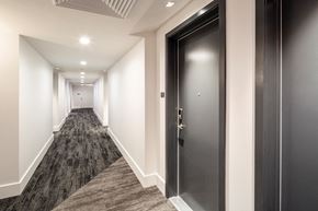 Washington apartment for rent - a corridor in a building with black doors and white walls