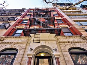 New York apartment for rent - a tall building with a fire escape on the side of it