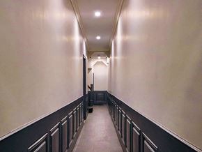 New York apartment for rent - a long hallway with black railings and white walls