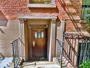 New York apartment for rent - the front door of an old brick house with a wooden door