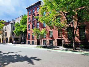 New York apartment for rent - a red brick apartment building on a city street