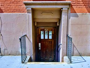 New York apartment for rent - a wooden door in front of a brick building