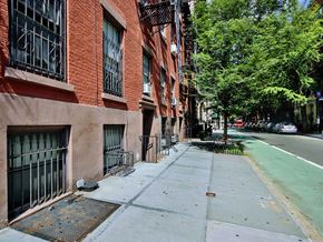 New York apartment for rent - a city street with brick buildings and trees