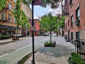New York apartment for rent - a city street with tall buildings and trees
