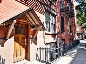New York apartment for rent - an old brick building with a wooden door