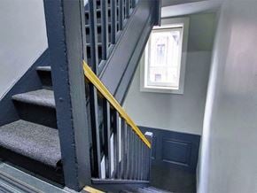 New York apartment for rent - a staircase with a metal railing and a window