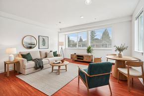 Seattle apartment for rent - A living room with a couch, chair, and table.
