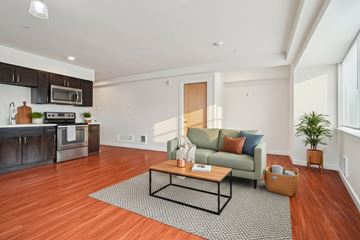 Seattle apartment for rent - A modern living room with a green couch and a coffee table.