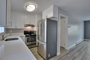 Redwood City apartment for rent - a kitchen with stainless steel appliances and white cabinets