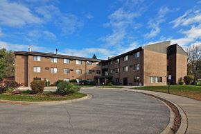 Maple Plain apartment for rent - a large brick building with a roundabout in front of it