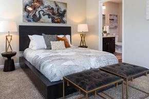 Concord apartment for rent - A bedroom with a large bed and a painting on the wall.