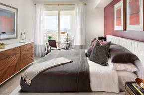Coral Gables apartment for rent - a bedroom with a bed and a pink accent wall