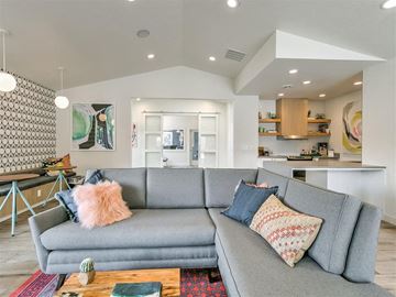 Boise apartment for rent - A grey couch with a pink pillow on it in a living room.