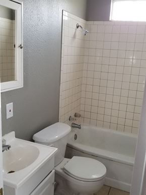 Abilene house for rent - a bathroom with a toilet and a tub and a sink