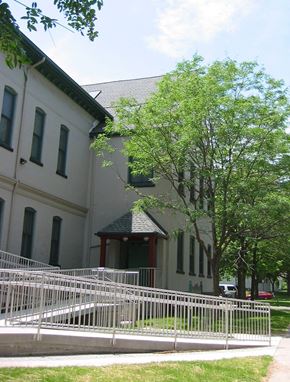 Rochester apartment for rent - a white fence in front of a building