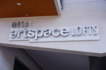 Mesa apartment for rent - a sign for mesa artspace loft on the side of a building