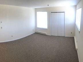 Guilford apartment for rent - an empty living room with white walls and a window