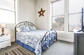 Menominee apartment for rent - a small bedroom with a bed and two windows