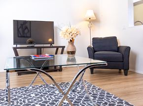Los Angeles apartment for rent - a living room with a glass table and a tv