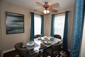 Winston-Salem apartment for rent - a dining room with a table and chairs and a ceiling fan