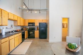 Columbus apartment for rent - a kitchen with black appliances and wooden cabinets
