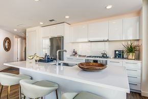 Seattle apartment for rent - a kitchen with white cabinets and a white counter top