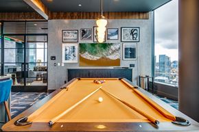 Seattle apartment for rent - a game room with a pool table and a view of the city