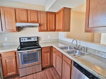 Kalamazoo apartment for rent - a kitchen with wooden cabinets and stainless steel appliances