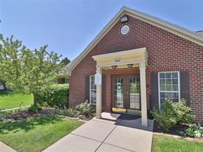 Kalamazoo apartment for rent - the front entrance of a brick building with a sidewalk