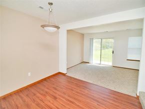 Kalamazoo apartment for rent - an empty living room with wood flooring and a sliding glass door