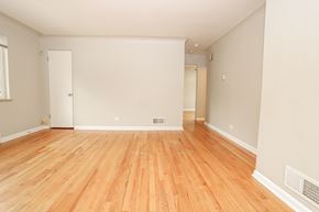 Denver apartment for rent - the living room and dining room of an empty house with wood floors