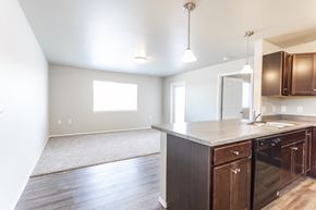 Sioux Falls townhouse for rent - a kitchen and living room with wood floors and a large window