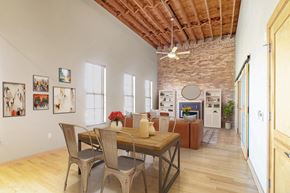 Sioux Falls apartment for rent - a dining room with a wooden table and chairs and a brick wall