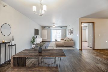 Sioux Falls townhouse for rent - a living room with a couch and a table and a tv