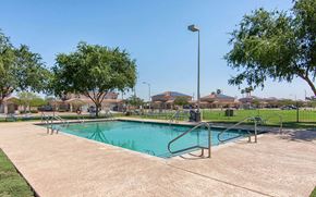 Glendale apartment for rent - a swimming pool with a fence and trees around it
