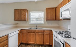 Glendale apartment for rent - a kitchen with white appliances and wooden cabinets